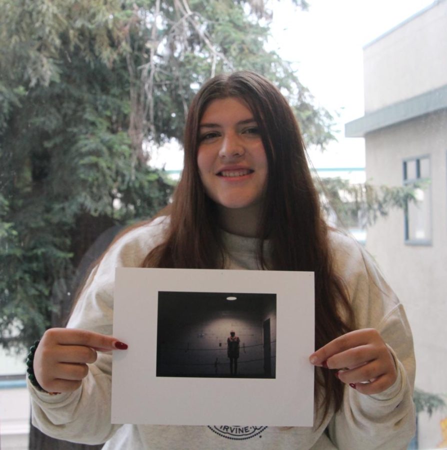 Sophia Girguis, 3rd place Portraits winner, posing with her photograph titled, On Display.