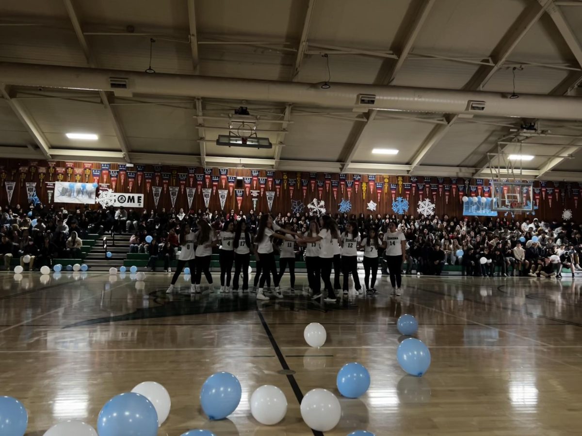 varsity soccer team performs at the winter rally