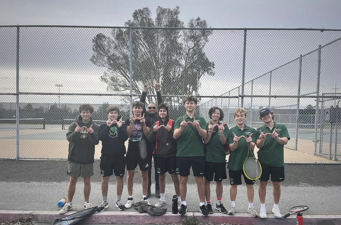 The+boys+tennis+team+holds+up+their+Ws+after+their+win+against+Casa+Grade+