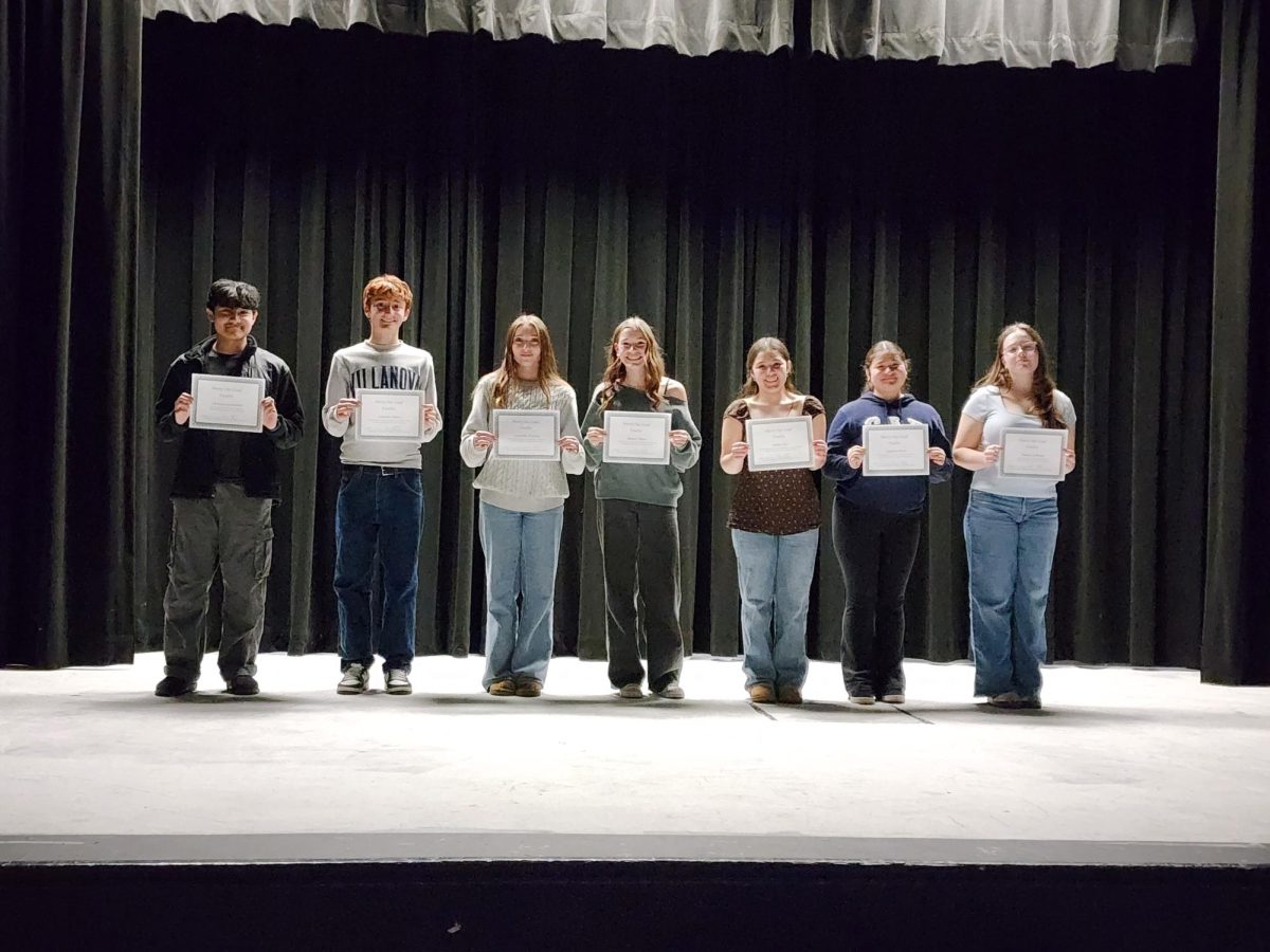 Seven students participated in the school-level poetry out loud competition. Samantha McGrane is third from left.