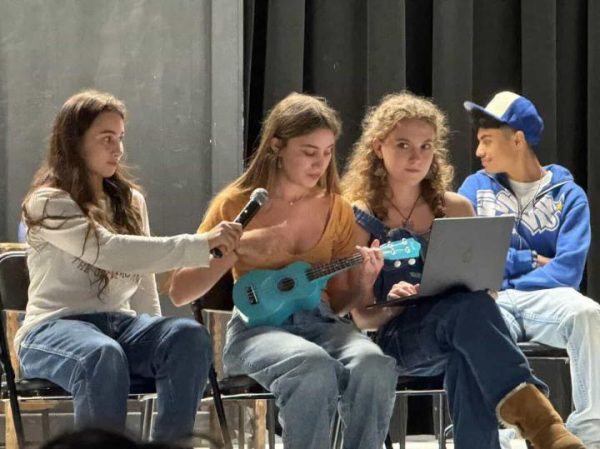 Next top dragon contestants sit on stage in the Little Theater during the competition
